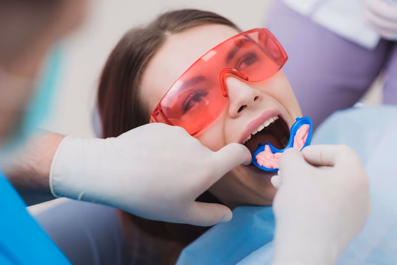 doctor orthodontist performs a procedure for cleaning teeth